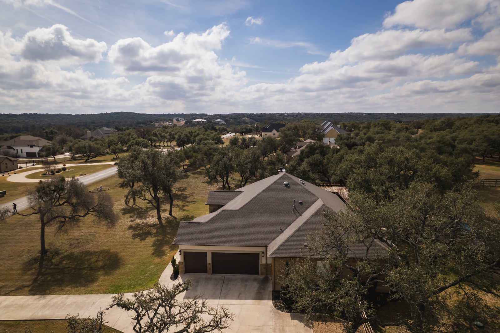 New shingle roof on a Hill Country home with three-car garage
