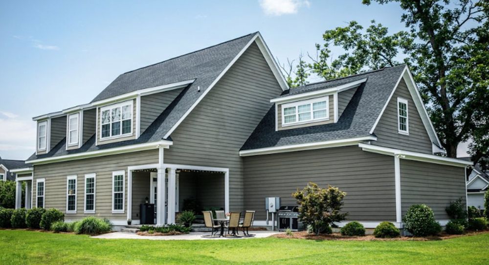New shingle roof on a gray two-story home